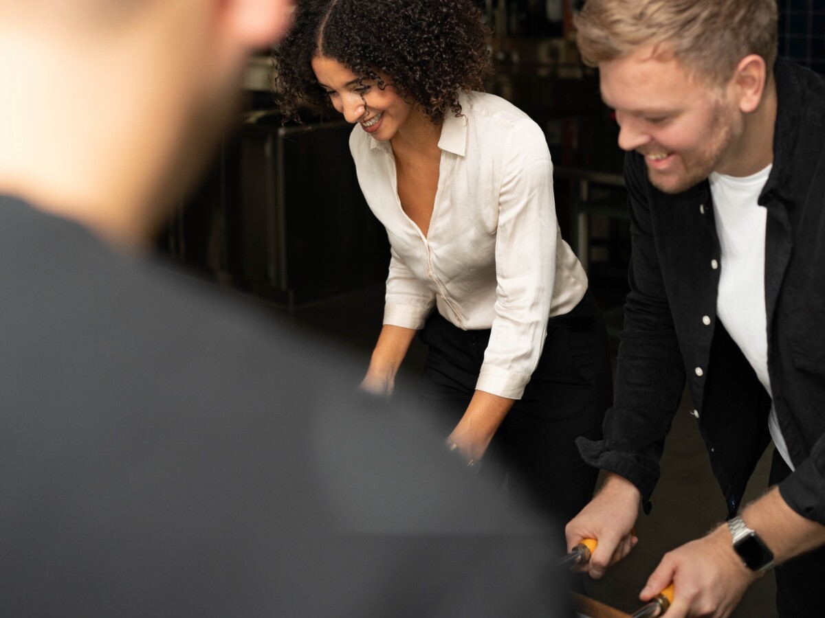 Two elaboratum employees playing table football